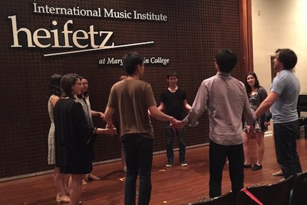 Heifetz students join together in a circle for a Communication Training course